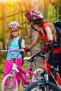 Bikes cycling family. Mother and daughter wearing helmet are cycling on bicycles . Royalty Free Stock Photo