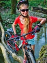 Bikes cycling girl cycling fording throught water .