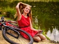 Bikes cycling girl. Girl has rest near bicycle into park. Royalty Free Stock Photo