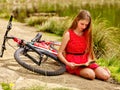 Bikes cycling girl has a rest and read book into park. Royalty Free Stock Photo