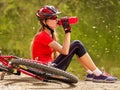 Bikes cycling girl wearing helmet. Girl cycling drinking of bottle water. Royalty Free Stock Photo