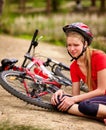 Bikes cycling girl wearing helmet. Kid fell off bike. Royalty Free Stock Photo