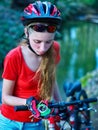 Bikes cycling girl wearing helmet look at compass. Royalty Free Stock Photo