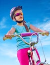 Bikes cycling girl wearing helmet rides bicycle. Royalty Free Stock Photo