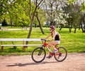 Bikes cycling girl wearing helmet riding on bicycle lane. Royalty Free Stock Photo