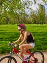Bikes cycling girl wearing helmet riding on bicycle lane. Royalty Free Stock Photo