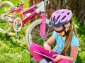 Bikes cycling girl wearing helmet watching at tablet pc . Royalty Free Stock Photo