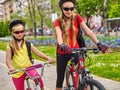 Bikes cycling girls with rucksack on bike lane. Royalty Free Stock Photo