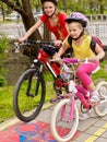 Bikes cycling girls with rucksack cycling on bike lane. Royalty Free Stock Photo