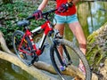 Bikes girl cycling fording throught water .