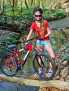 Bikes girl cycling fording throught water . Royalty Free Stock Photo