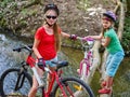 Bikes girl cycling fording throught water .