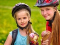 Bikes girls cycling eating ice cream cone in park. Royalty Free Stock Photo