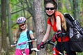 Bikes girls. Happy family wearing helmet are cycling on bicycles . Royalty Free Stock Photo