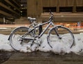 Bikes in Toronto at night with snow on them