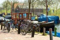 Bikes and Traditional Dutch Botter Fishing Boats in the small Harbor of the Historic Fishing Village in Netherlands. Royalty Free Stock Photo