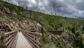 Biking over the Wooden Trestle Bridges of the abandoned Kettle Valley Railway in Myra Canyon Royalty Free Stock Photo