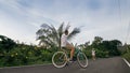 Biking road trip. The man on blue bike in white clothes on forest road. The biker men ride on bicycle. Cycling Cycle Fix Royalty Free Stock Photo