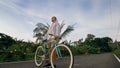 Biking road trip. The man on blue bike in white clothes on forest road. The biker men ride on bicycle. Cycling Cycle Fix Royalty Free Stock Photo