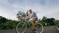 Biking road trip. The man on blue bike in white clothes on forest road. The biker men ride on bicycle. Cycling Cycle Fix Royalty Free Stock Photo