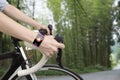 Biking woman hands wearing health sensor smart watch Royalty Free Stock Photo