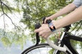 Biking woman hands wearing health sensor smart watch Royalty Free Stock Photo