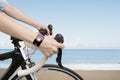 Biking woman hands wearing health sensor smart watch Royalty Free Stock Photo