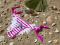 Bikini bottom and sunglasses on beach sand in sunlight Royalty Free Stock Photo