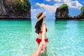 Bikini girl holding man`s hand and leading him to koh hong island in Krabi, Thailand Royalty Free Stock Photo