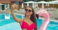 Bikini girl making photos on beach Summer, girl take selfie at pool. Beautiful young woman in summer wih smartphone Royalty Free Stock Photo