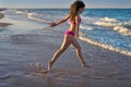 Bikini girl running to the beach shore water Royalty Free Stock Photo
