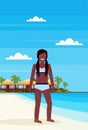 Bikini woman on tropical island with villa bungalow hotel on beach seaside green palms landscape summer vacation concept