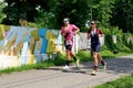 The athletes compete in running component on embankment near Ros river during national triathlon competition of Ukraine