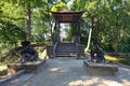 Front view of scenic Chinese Bridge with Sculptures of Chinese wise man and young woman with umbrella. Royalty Free Stock Photo