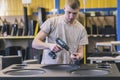 Bila Tserkva, Ukraine, March 2021: Worker assembles a huge music speaker in a factory