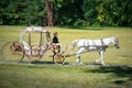 Bila Tserkva, Ukraine, SEP 2, 2017 A carriage and a white horse passing through a summer park