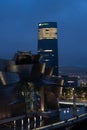 Guggenheim Museum in Bilbao designed by architect Frank Gehry with the Iberdrola tower Royalty Free Stock Photo