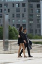 A couple dressed in black walk