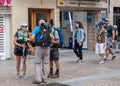 Bilbao, Spain , October 1, 2019 .    Tourists  with  backpacks and nordic walking sticks  at a street of Bilbao Royalty Free Stock Photo