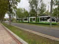 Bilbao tramway in motion on a cloudy day on grassy tracks Royalty Free Stock Photo