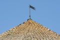 Bilhorod Dnistrovskyi, Odesa region, Ukraine - July 18th, 2021: Old tiled roof with a weather vane on top of the tower of the Royalty Free Stock Photo