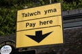 Bilingual pay here sign in Betws-y-coed car park North Wales March 2020 Royalty Free Stock Photo