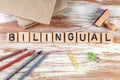 Bilingual. Textbooks, stationery and a wooden stamp on the table Royalty Free Stock Photo