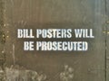 Bill Posters Will Be Prosecuted Sign on Black Wall