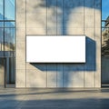 Billboard on a concrete wall of a building with shadows and glass facade in daylight setting Royalty Free Stock Photo