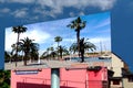 Large billboard ad panel in urban setting with blue sky background. sample composite image with travel theme.