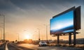 Billboard standing tall beside a bustling highway under a moody sunset sky