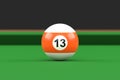 Billiard ball number thirteen in orange and white color on billiard table