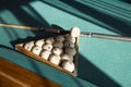 Billiard balls arranged in a triangle rack with cues on table Royalty Free Stock Photo