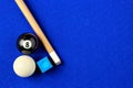 Billiard balls, cue and chalk in a blue pool table. Royalty Free Stock Photo